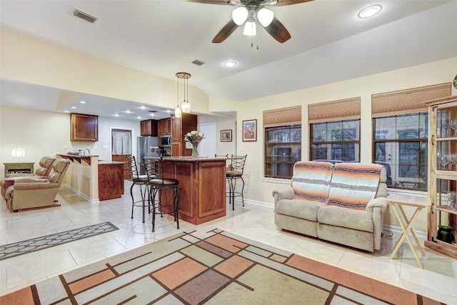 living room featuring recessed lighting, light tile patterned floors, ceiling fan, visible vents, and baseboards