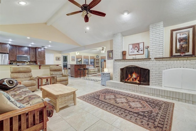 living area featuring light tile patterned floors, beamed ceiling, ceiling fan, a fireplace, and high vaulted ceiling