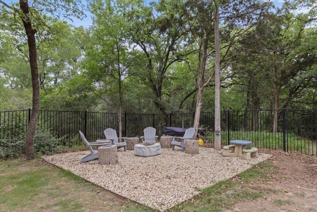 view of yard featuring fence and a fire pit