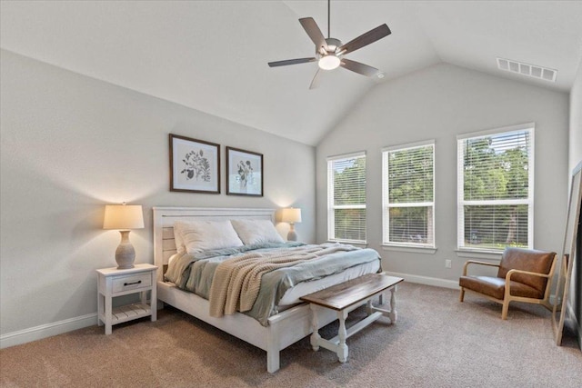 bedroom featuring lofted ceiling, visible vents, multiple windows, and baseboards