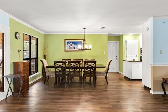 205 Kamakoa Ln, Bastrop, TX 78602 - dining room featuring dark wood-type flooring, a chandelier, and ornamental molding