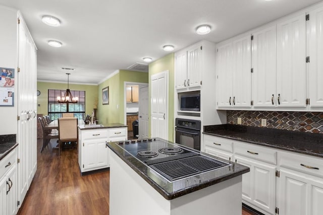 kitchen featuring white cabinetry, dark wood-style floors, a center island, oven, and ornamental molding