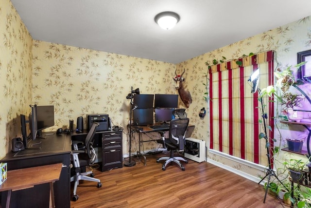 office space featuring wallpapered walls and wood finished floors