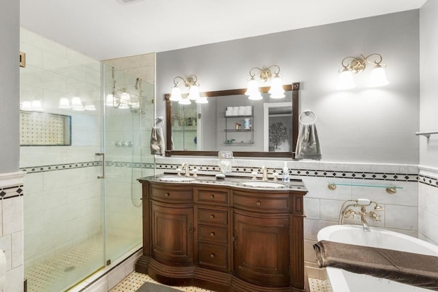 205 Kamakoa Ln, Bastrop, TX 78602 - bathroom featuring a stall shower, a garden tub, double vanity, tile walls, and wainscoting