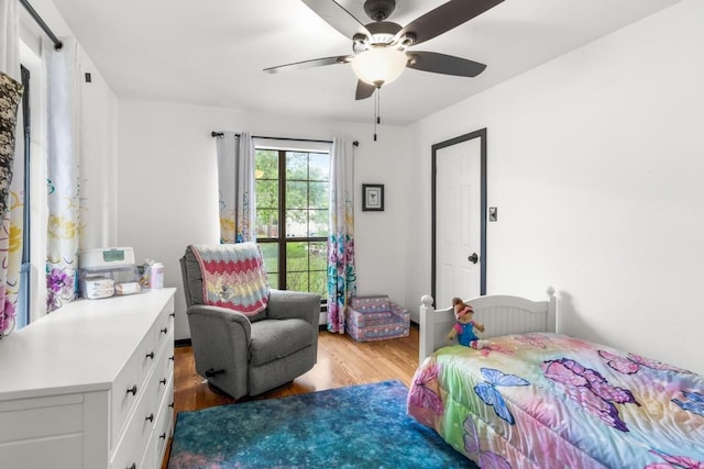 bedroom with a ceiling fan and light wood-style floors