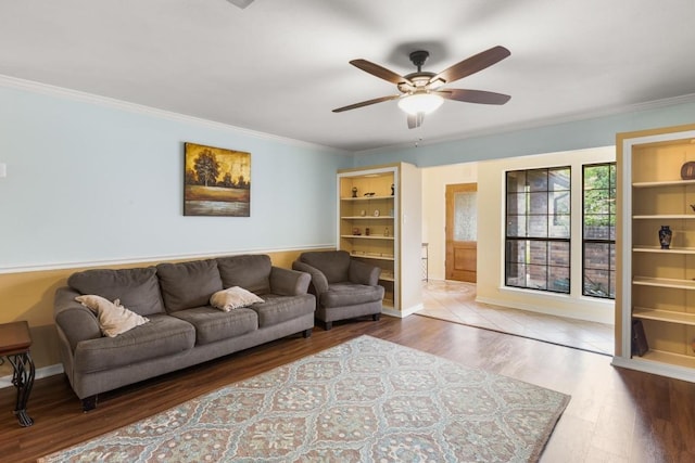 living room featuring baseboards, wood finished floors, ceiling fan, and ornamental molding