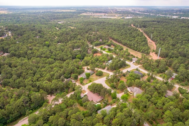 bird's eye view featuring a wooded view