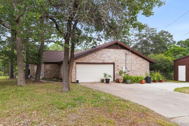 view of property exterior with a lawn, driveway, an attached garage, and brick siding