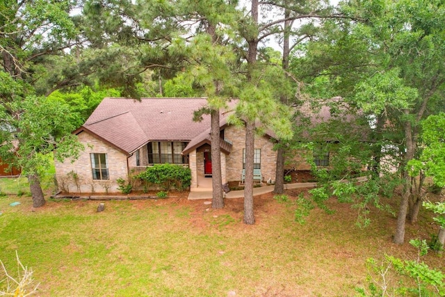 205 Kamakoa Ln, Bastrop, TX 78602 - view of front of house featuring roof with shingles and brick siding