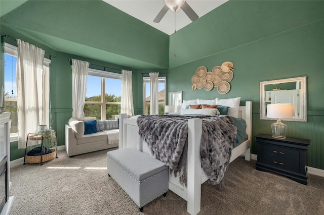 bedroom with a ceiling fan, a wainscoted wall, and carpet flooring