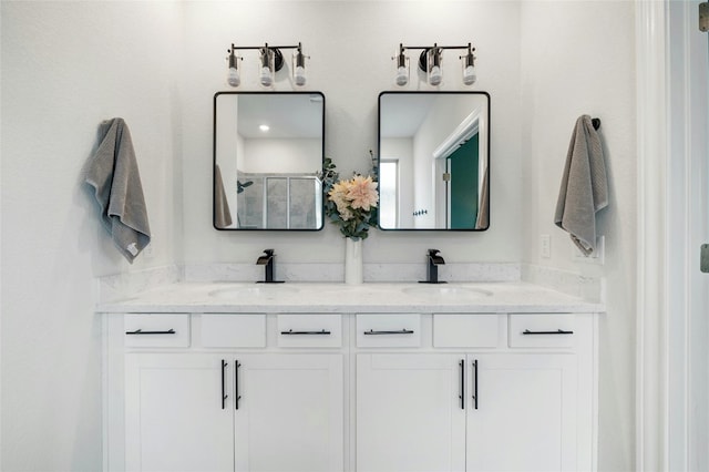bathroom with a sink and double vanity