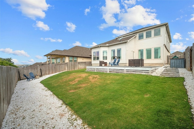 back of property featuring central AC, a fenced backyard, and a lawn