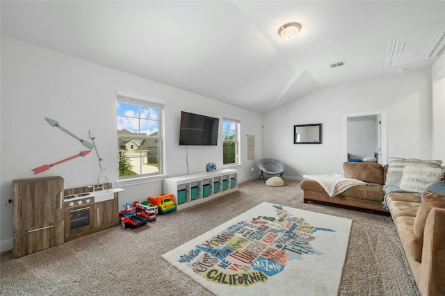carpeted living area with attic access, visible vents, lofted ceiling, and baseboards