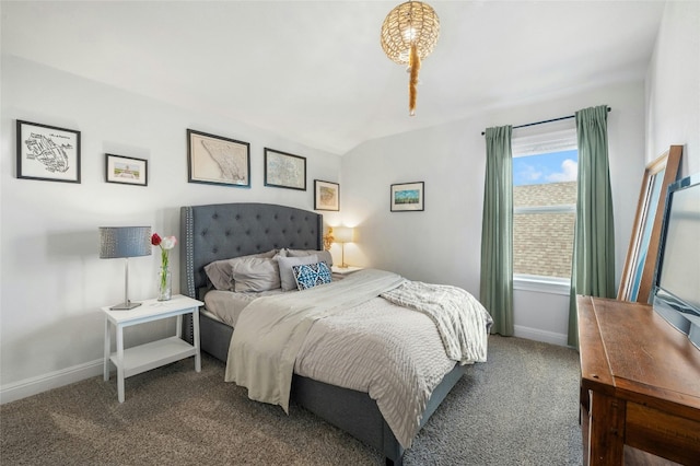 bedroom with baseboards, carpet floors, and lofted ceiling