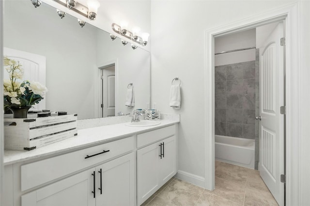 bathroom featuring tub / shower combination, tile patterned flooring, vanity, and baseboards