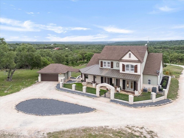 440 Currie Ranch Rd, Wimberley, TX 78676 - view of front of property featuring a garage, a porch, a view of trees, and a fenced front yard
