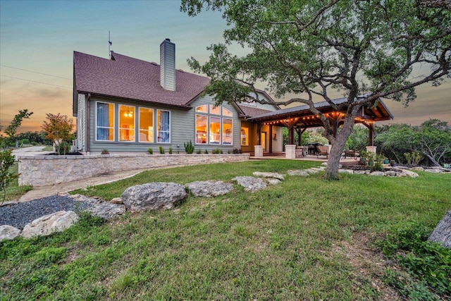 440 Currie Ranch Rd, Wimberley, TX 78676 - back of house with a yard, a shingled roof, and a chimney