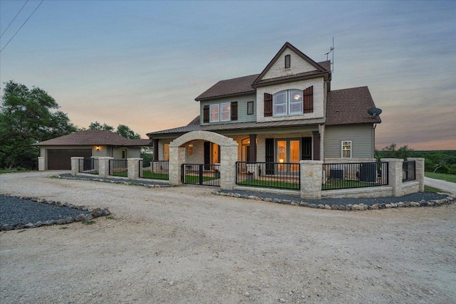 440 Currie Ranch Rd, Wimberley, TX 78676 - view of front of home featuring covered porch, a standing seam roof, fence, a garage, and stone siding