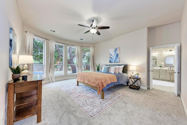 bedroom with multiple windows, baseboards, light carpet, and visible vents