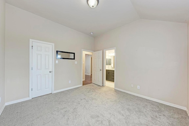2402 Silent Brook Trl, Round Rock, TX 78665 - unfurnished bedroom featuring carpet, vaulted ceiling, and ensuite bath