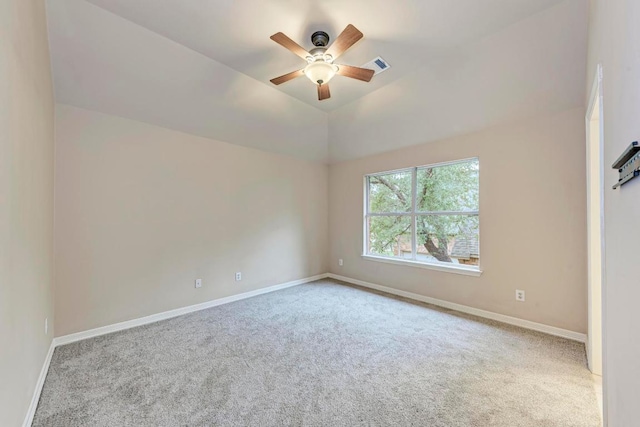 carpeted empty room with baseboards, visible vents, and ceiling fan