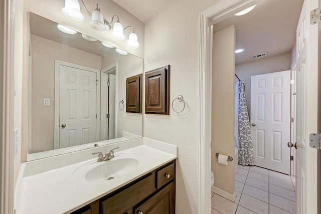 bathroom featuring a shower with curtain, vanity, tile patterned floors, toilet, and visible vents