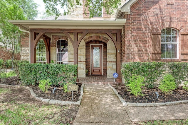 2402 Silent Brook Trl, Round Rock, TX 78665 - property entrance with brick siding, covered porch, and stone siding