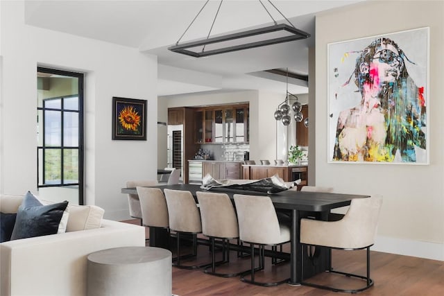 dining room featuring baseboards and wood finished floors