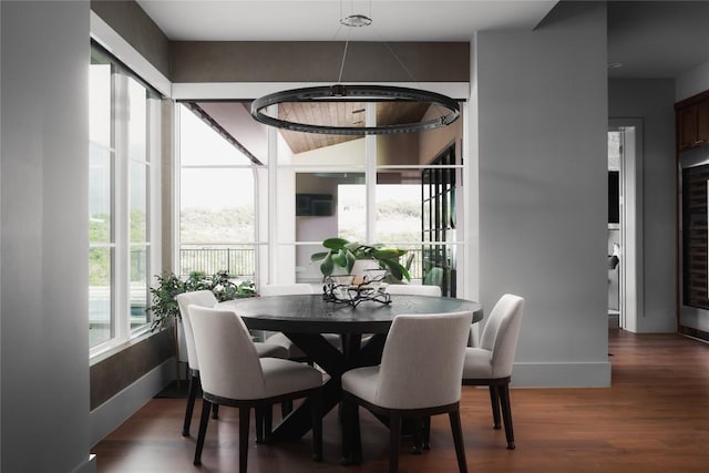 dining area with baseboards, wood finished floors, and wine cooler