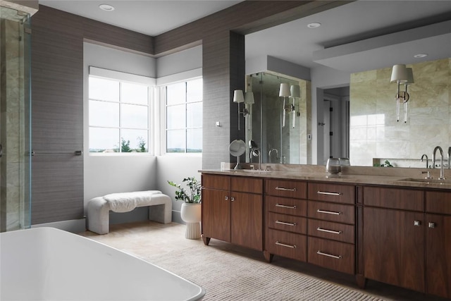 bathroom featuring a freestanding bath, a stall shower, double vanity, and a sink