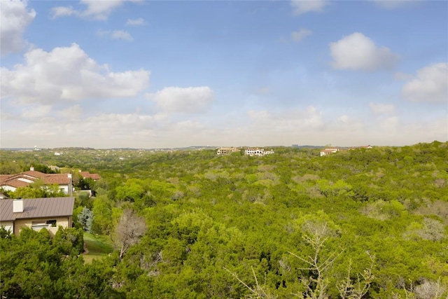 drone / aerial view with a wooded view