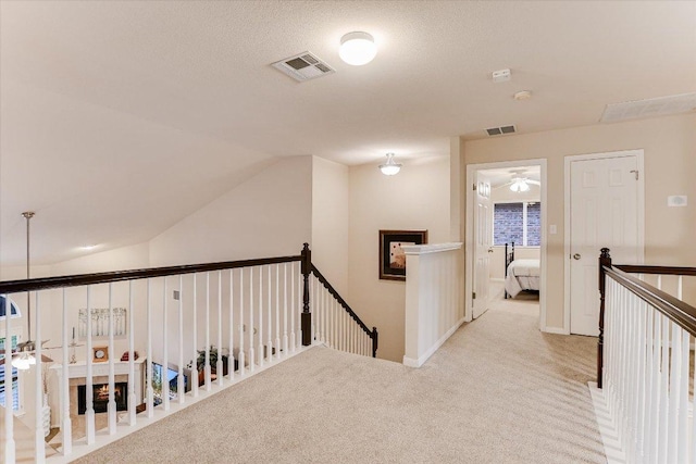 15617 Pumpkin Ridge Dr, Austin, TX 78717 - hallway featuring an upstairs landing, carpet flooring, vaulted ceiling, and baseboards