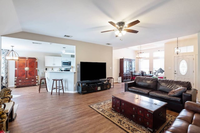 4906 Thunderbird Dr, Lago Vista, TX 78645 - living area featuring a ceiling fan, light wood-type flooring, a chandelier, and lofted ceiling