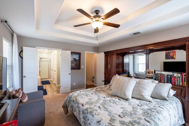 4906 Thunderbird Dr, Lago Vista, TX 78645 - carpeted bedroom with a tray ceiling and ceiling fan