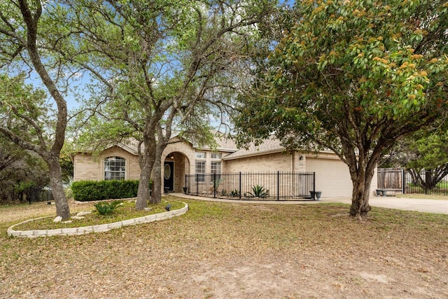 4906 Thunderbird Dr, Lago Vista, TX 78645 - obstructed view of property with concrete driveway, brick siding, and an attached garage