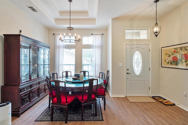 4906 Thunderbird Dr, Lago Vista, TX 78645 - dining area with a chandelier, wood finished floors, and a raised ceiling