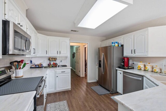4906 Thunderbird Dr, Lago Vista, TX 78645 - kitchen featuring stainless steel appliances, white cabinetry, and decorative backsplash