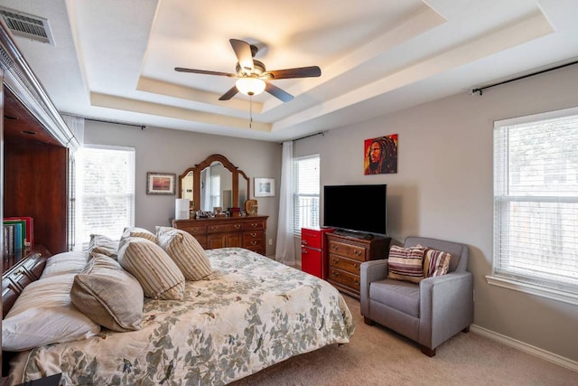 4906 Thunderbird Dr, Lago Vista, TX 78645 - bedroom with a tray ceiling, light colored carpet, and a ceiling fan