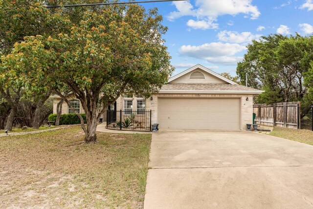 4906 Thunderbird Dr, Lago Vista, TX 78645 - view of front of home with driveway, a garage, and brick siding
