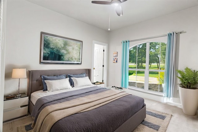 carpeted bedroom with ceiling fan and multiple windows