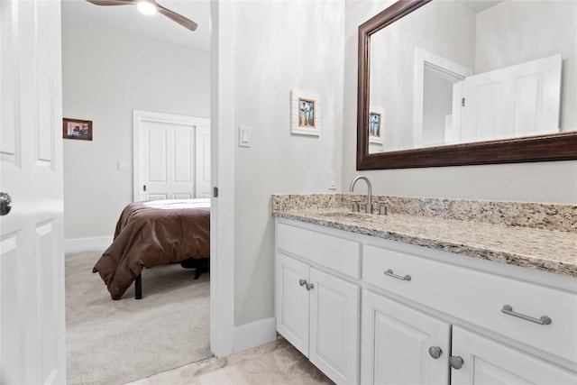bathroom featuring a ceiling fan, vanity, and baseboards