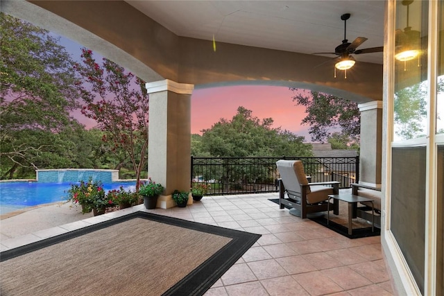 view of patio featuring a ceiling fan and a fenced in pool