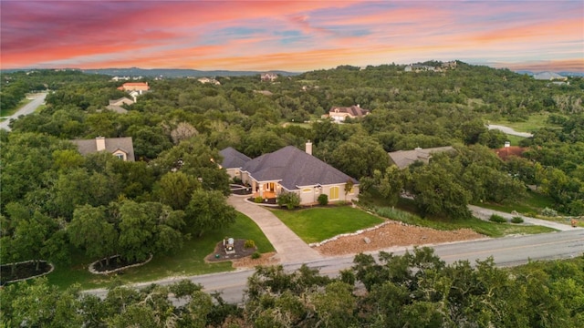 birds eye view of property with a forest view