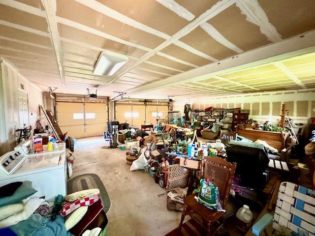 garage featuring a garage door opener and washing machine and clothes dryer