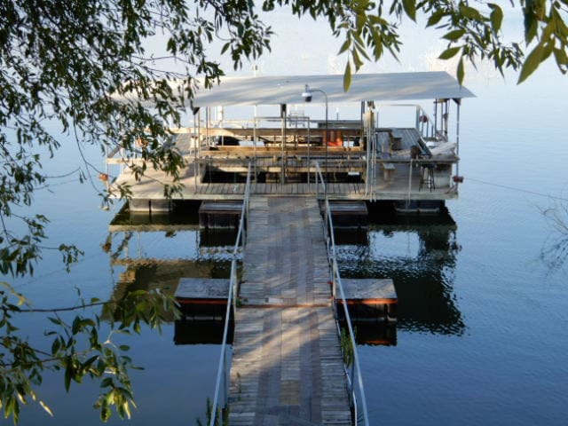 view of dock with boat lift and a water view