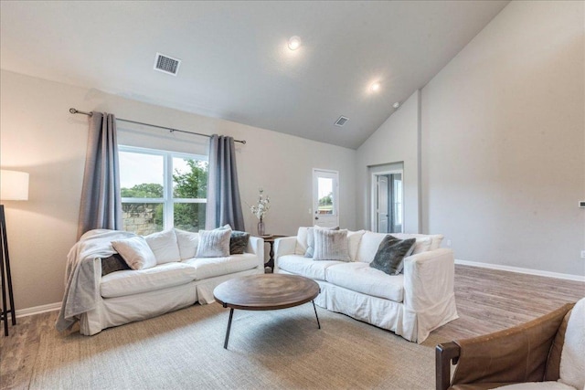 living room with baseboards, high vaulted ceiling, visible vents, and recessed lighting