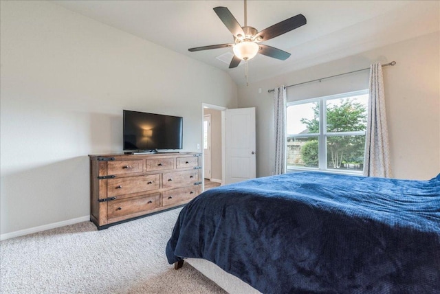 bedroom with baseboards, lofted ceiling, ceiling fan, and carpet