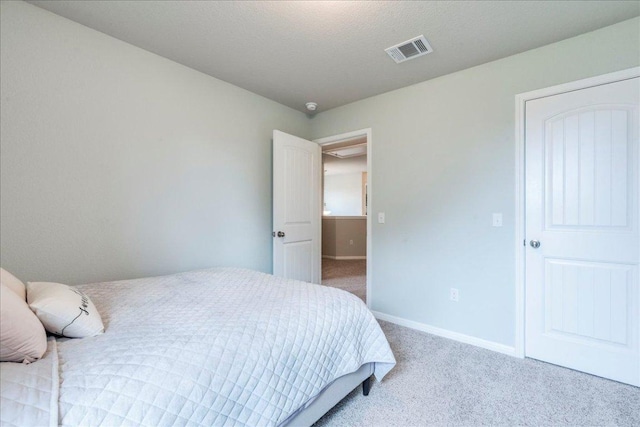 carpeted bedroom with baseboards and visible vents
