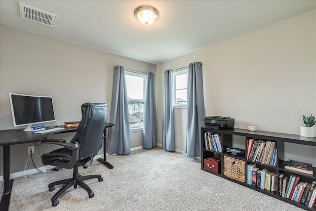 carpeted home office featuring baseboards and visible vents