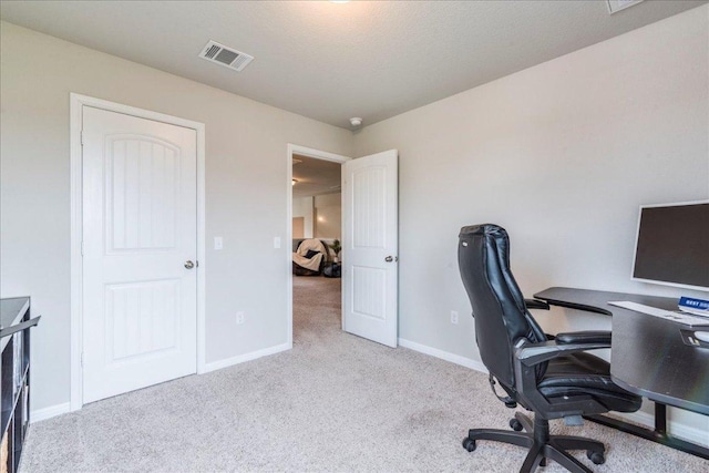 home office featuring carpet, visible vents, and baseboards